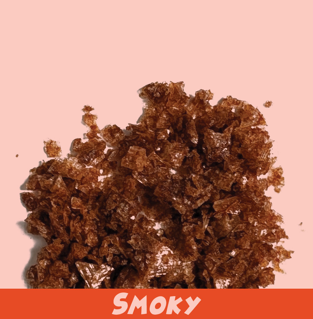 Smoky brown chilli salt flakes on a pink background with 'SMOKY' text.